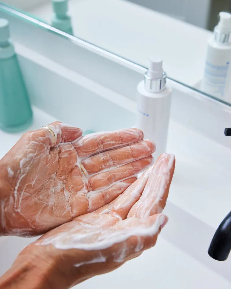 Lathered hands demonstrating gentle cleansing with Bio-Cleanse 5.5 Fac