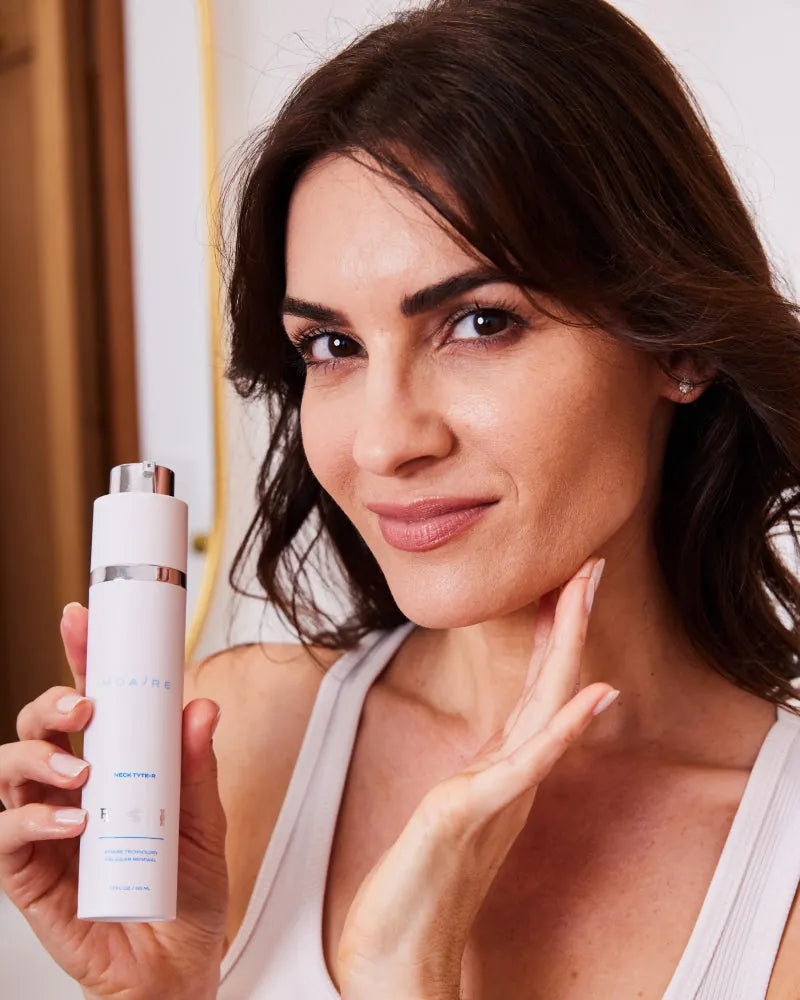 Woman holding MDAiRE Neck Tyte-R bottle demonstrating Skincare Essenti