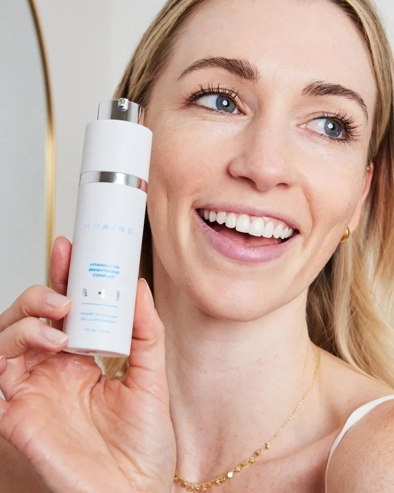 Woman smiling while holding Correct and Protect Duo in gallery positio