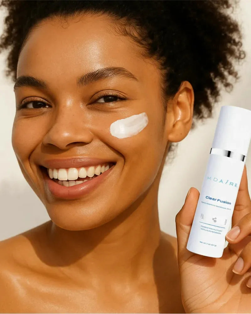 Smiling woman with radiant skin applying Clear Fusion Sunscreen with v